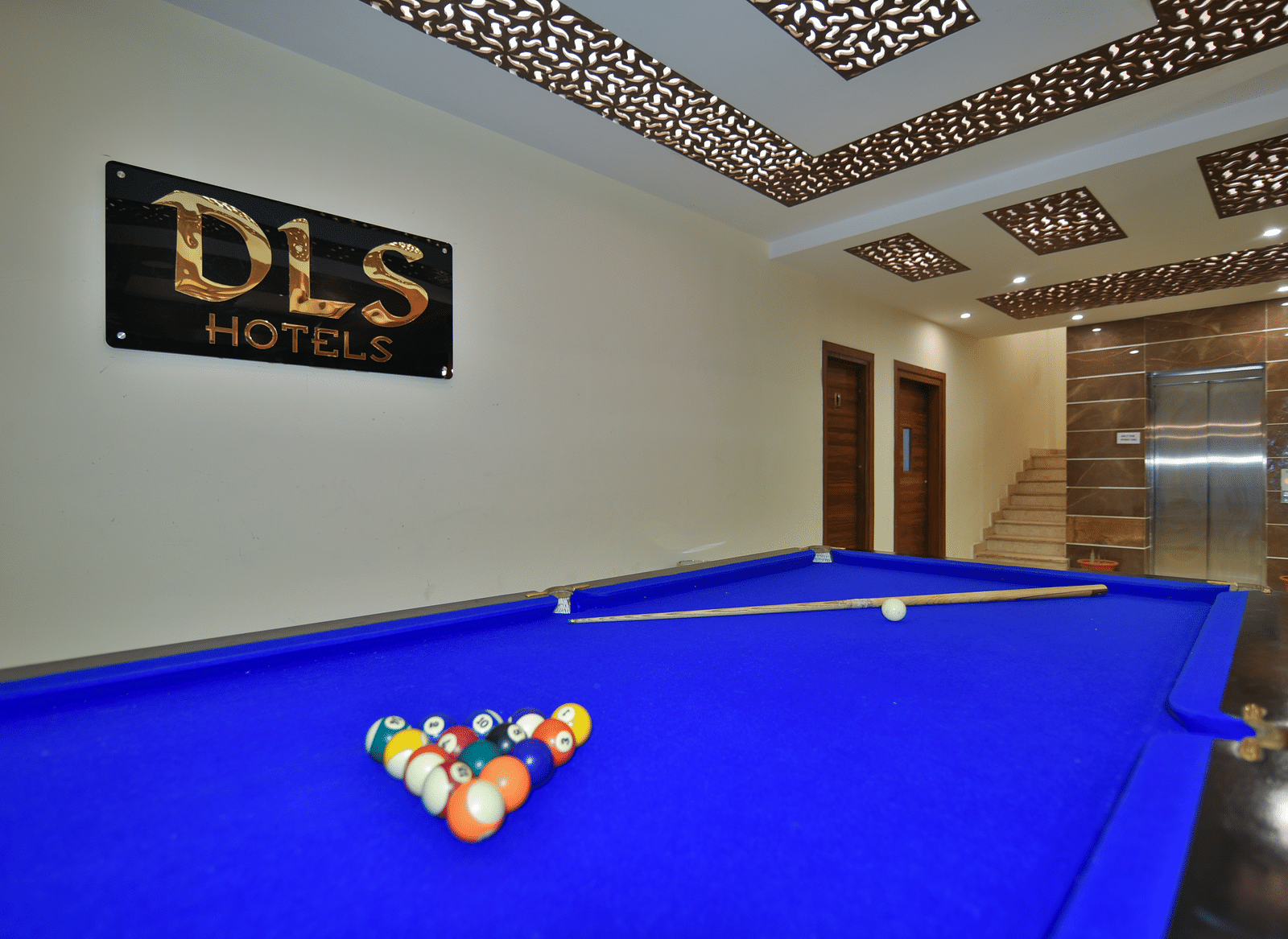 A pool table with billiard balls placed on the table at DLS Highland Resort and Spa, Mussoorie.